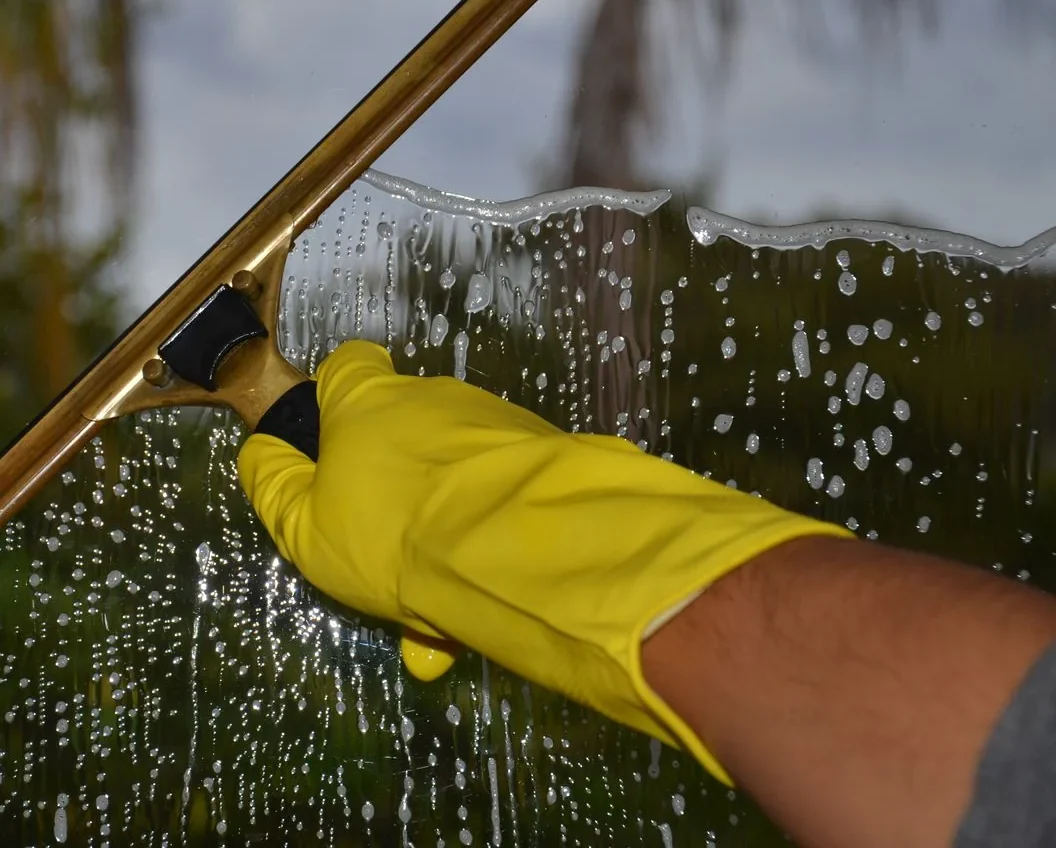 Window cleaning with a squeegee and soapy water